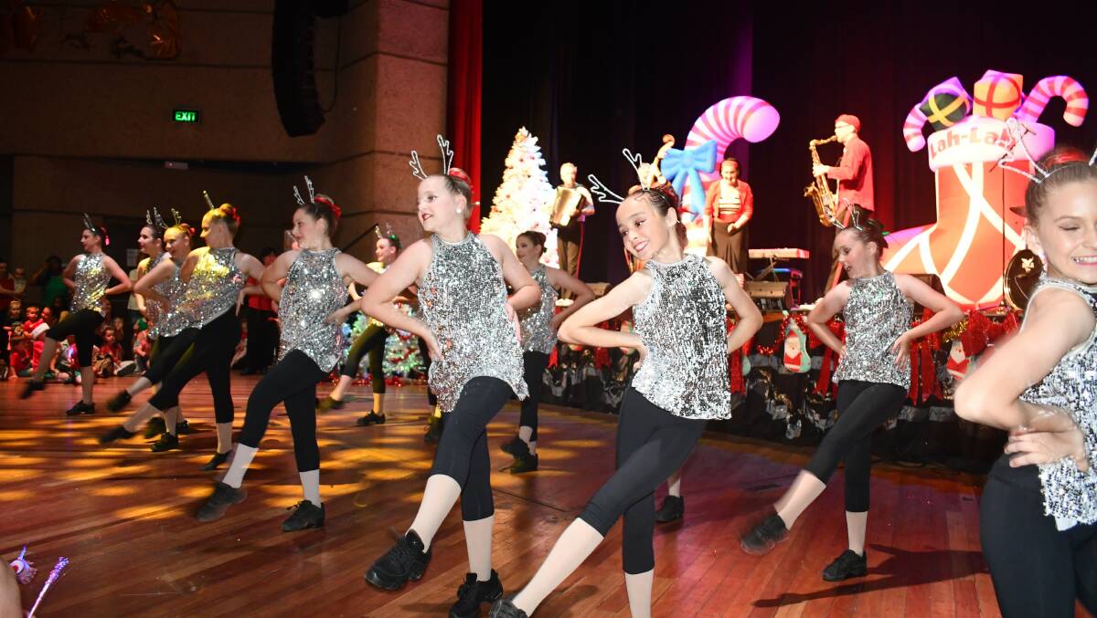 FESTIVE CHEER: Mount Isa School of Dance perform with band Lah-Lah at the recent Christmas in the City celebrations in Mount Isa. Photo: Derek Barry