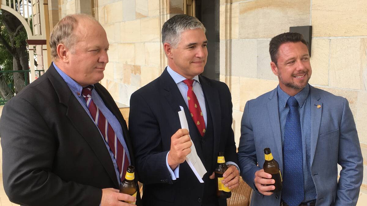 CHEERS: KAP members Shane Knuth, Robbie Katter and Nick Dametto salute the passing of the remote pubs bill in Brisbane Tuesday.