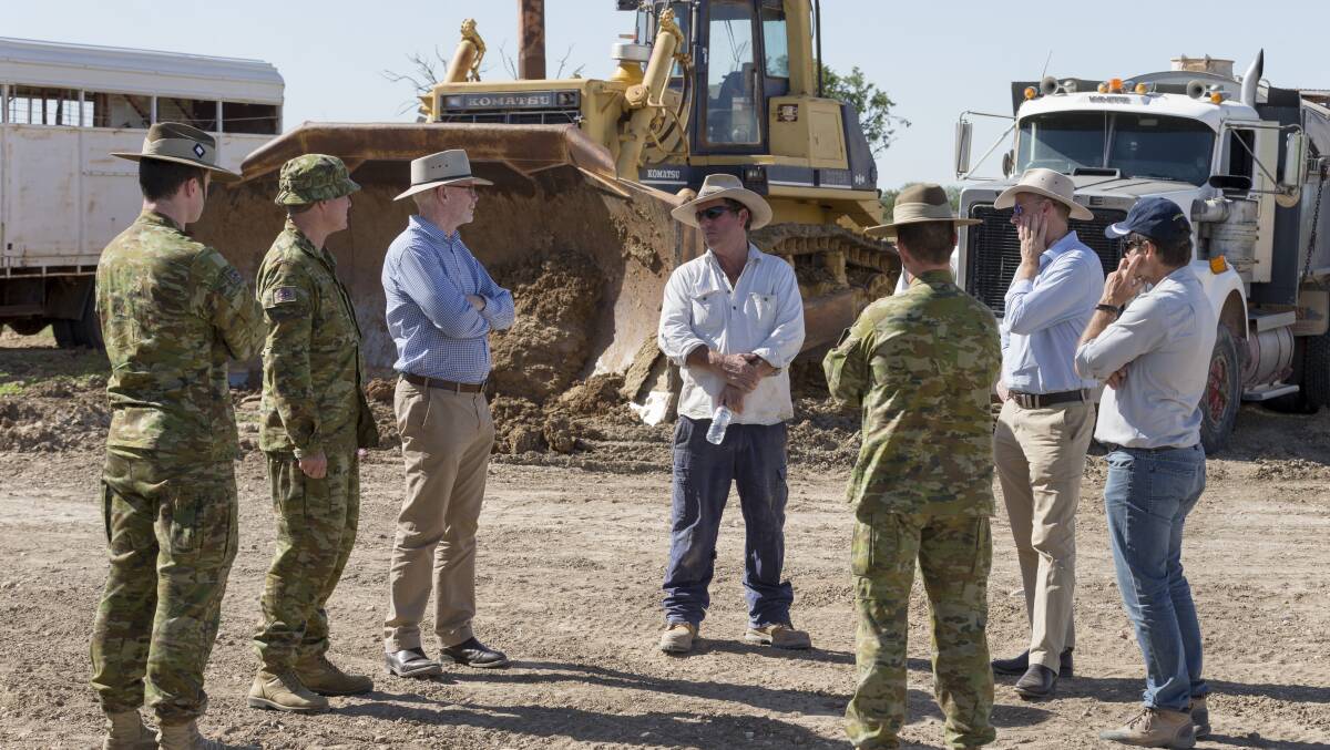 ACTION: Qld chief biosecurity officer Malcolm Letts (third left) chats with locals and army personnel about the carcass clean-up. Photo: supplied