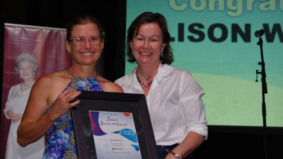 Cr Peta MacRae (right) hands Alison Whitehead her senior sports award at the Mount Isa Australia Day awards. Photo: Derek Barry
