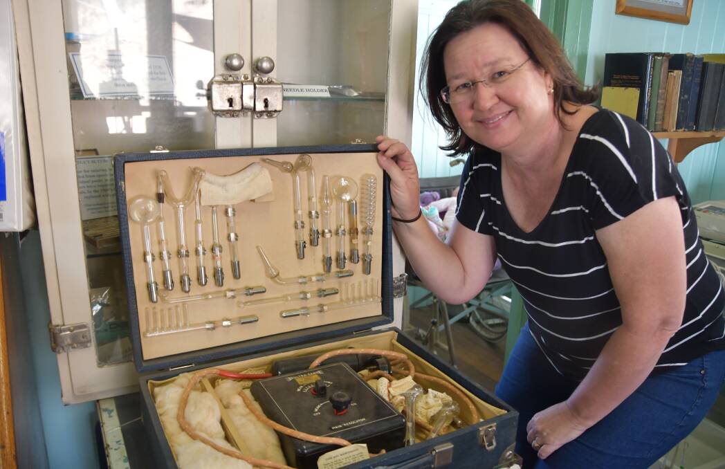 Underground Hospital volunteer coordinator Erica Shaw with one of the unidentified pieces of medical equipment in the Museum.