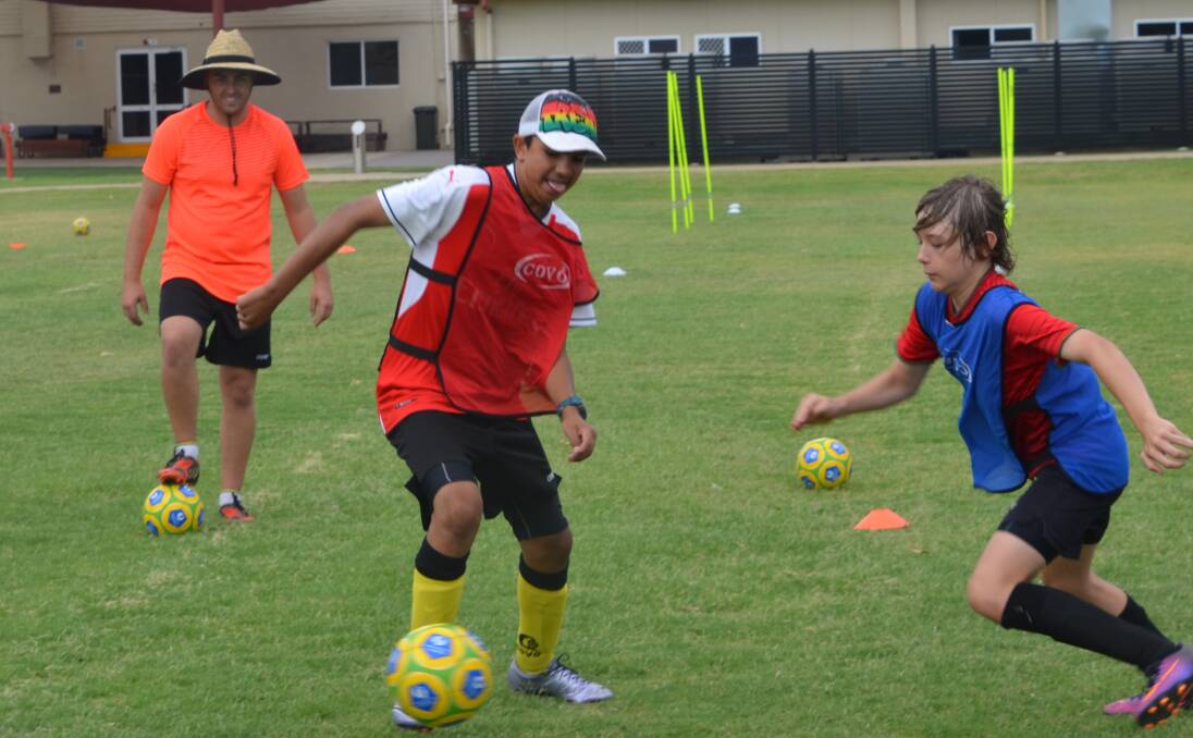SKILLS: Dean Kelley puts local youths through their paces at a soccer clinic in Mount Isa on the weekend. Photo: Derek Barry
