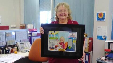 DEDICATION: Evelyn Arnold with the portrait done of her to celebrate 40 years of service to Townview State School.