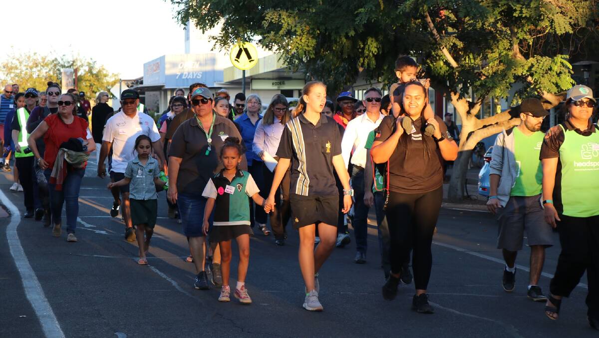 People march through the streets of Mount Isa on Tuesday on World Suicide Prevention Day.
