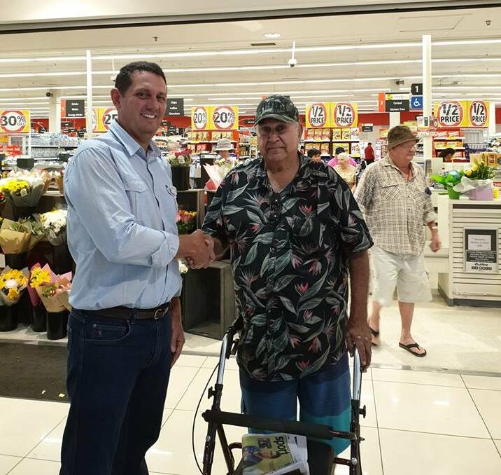 LNP candidate Brett McGuire (left) campaigns in Mount Isa, seen here with Joe Rogers,