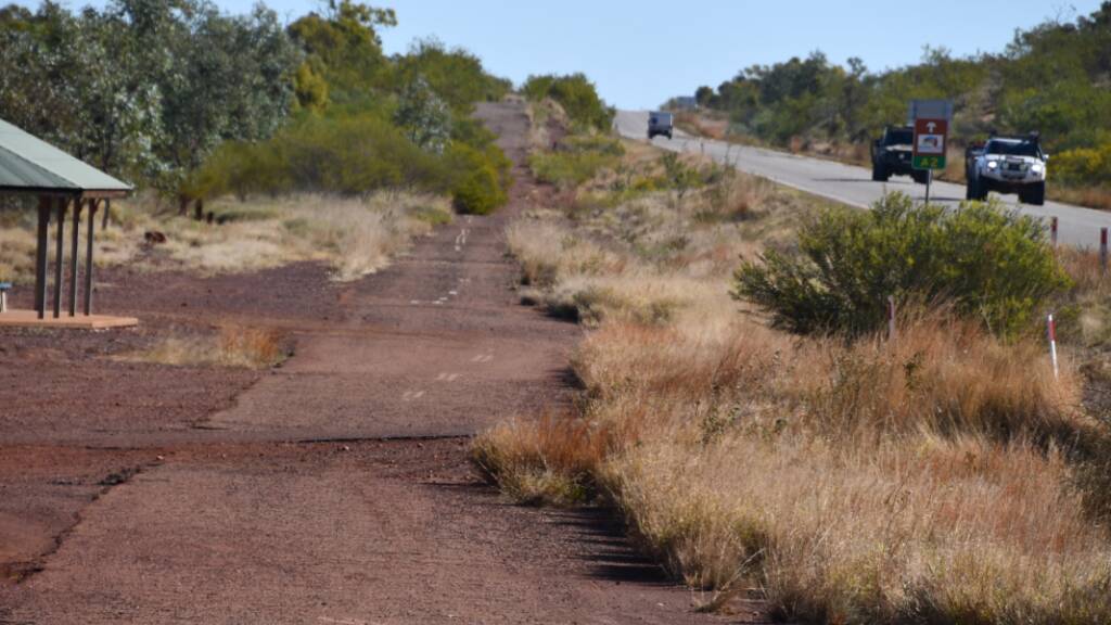 The caravan resting site 50km west of Mount Isa, with sections of the old road next to the new Barkly Highway.