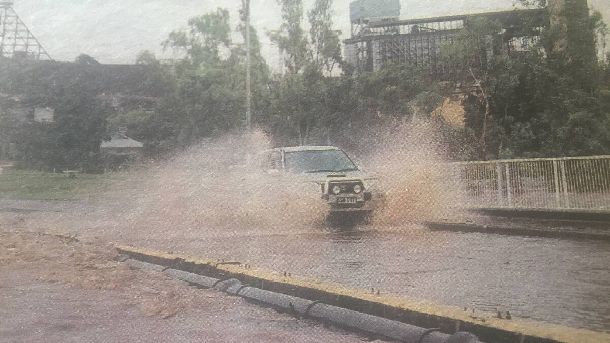 Flooding on the old Isa St bridge after Cyclone Yasi.