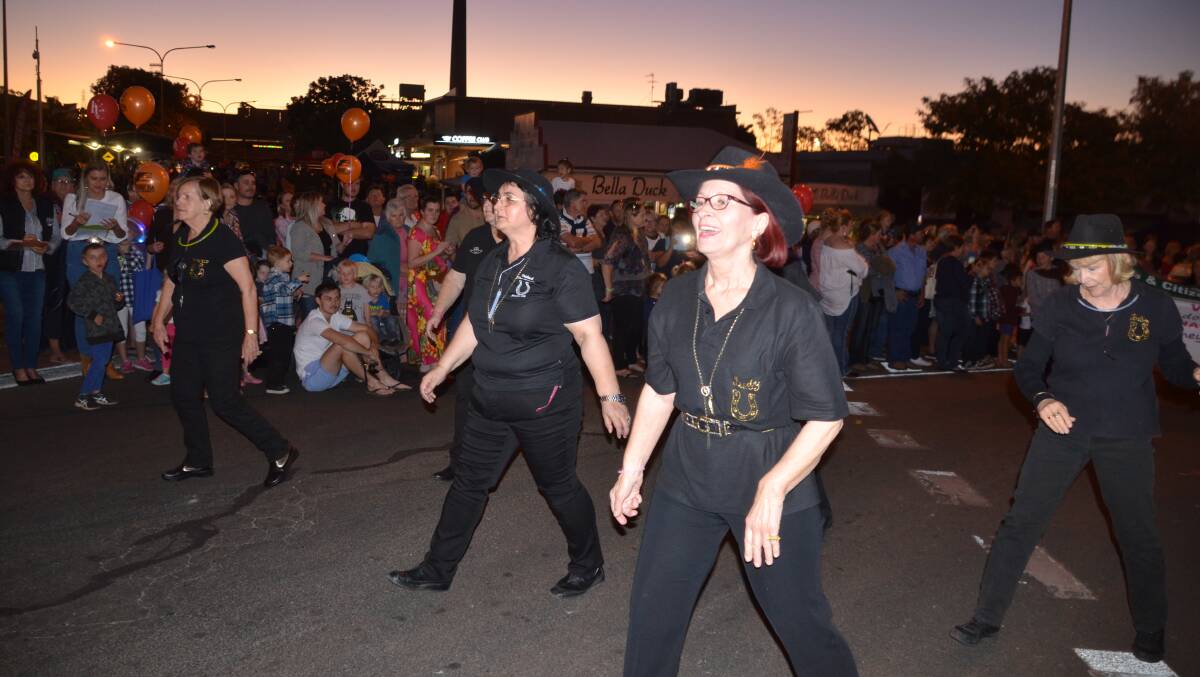 BARN DANCE: The Mount Isa Linedancers do a bit of bootscooting in the Isa Street Festival parade. Photos: Derek Barry