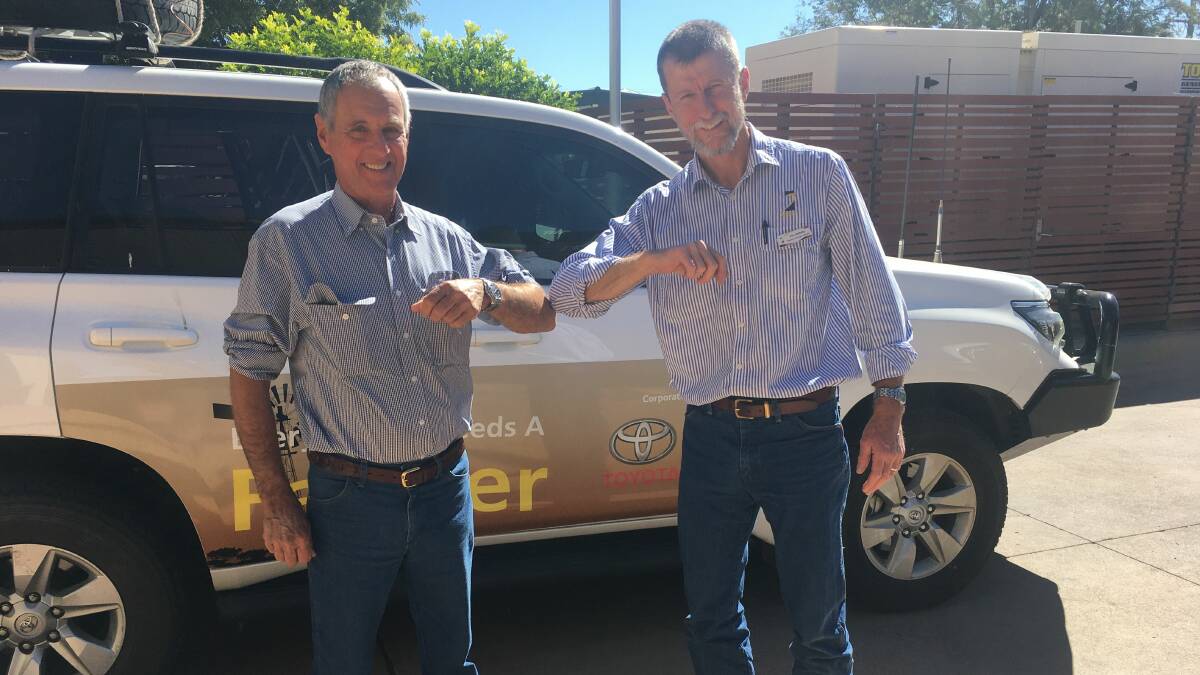 Julia Creek grazier Mark Bryant greets Agforce's Vol Norris,in the new preferred way.