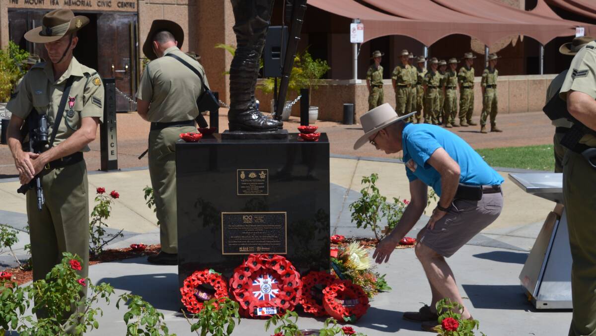 NEVER FORGET: Attendees place wreaths at the Mount Isa Cenotaph in the 99th anniversary of Remembrance Day in 2017. Photo:file