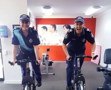BIG WEEKEND: Queen Quester Aimee Sewell (left) and PCYC manager Sgt Bernadette Strow get on the exercise bikes ahead of the challenge.