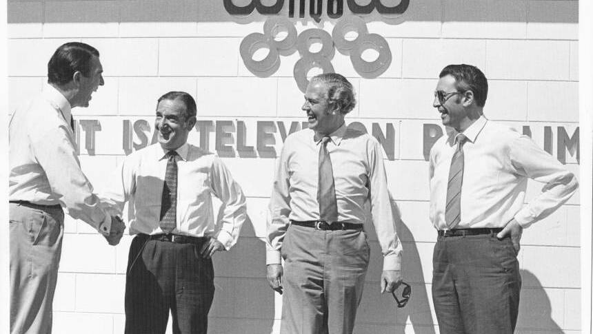 TELLY TIME: Herb Lilburn shakes hands with Sir Asher Joel to celebrate the arrival of commercial TV in Mount Isa in 1971.