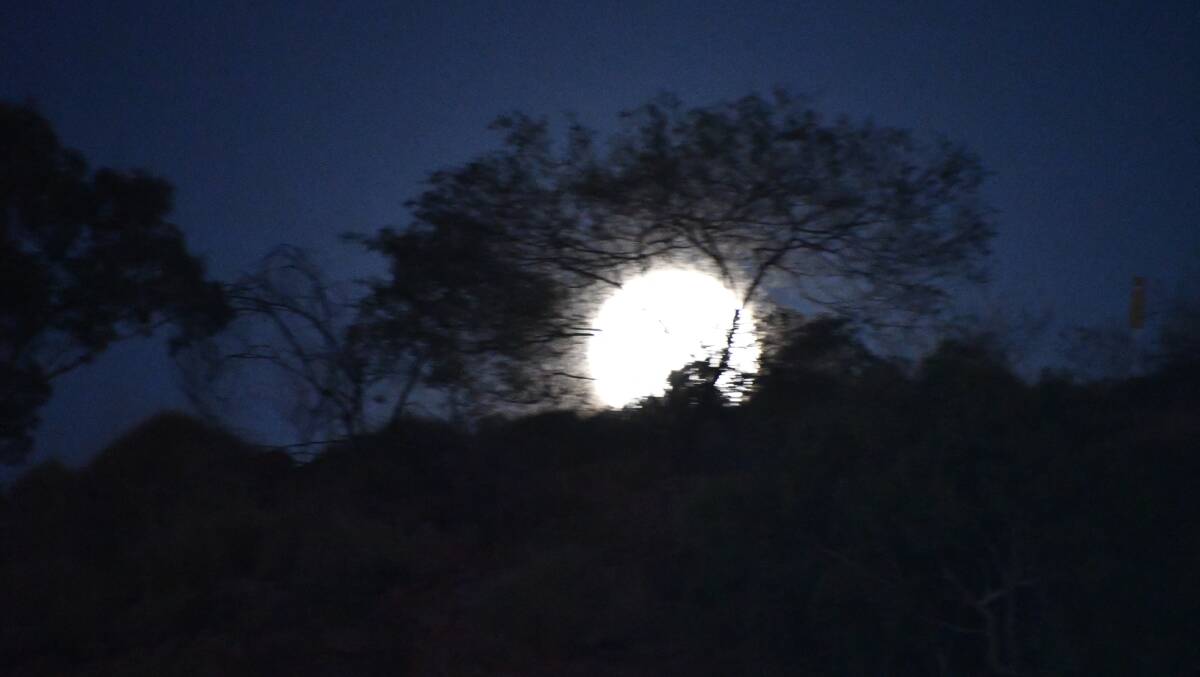 BLUE MOON: A full moon rises over the hills behind the Mount Isa soccer fields on Halloween. Photo: Derek Barry