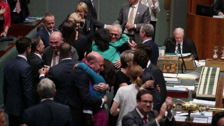 Parliamentarians congratulation each other after the SSM marriage vote. Photo: Alex Ellinghausen