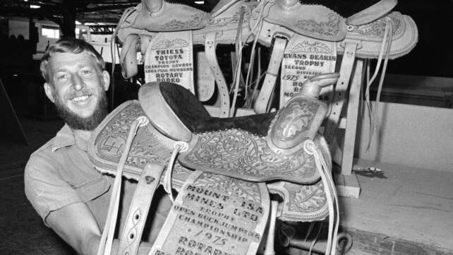 Donny Cummins showcases the winners' trophy saddles for the Rodeo.