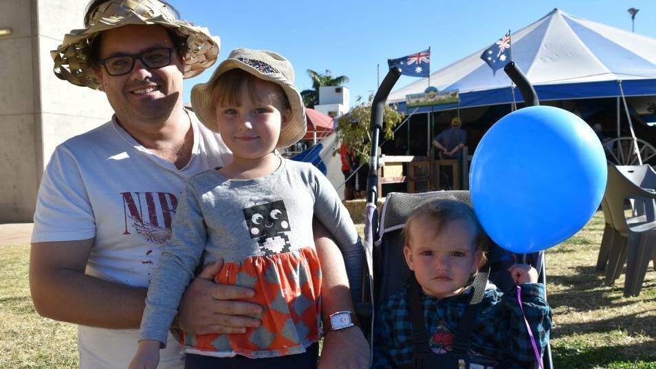 Simon Ives with children Willow and River at the 2018 Mount Isa Show.