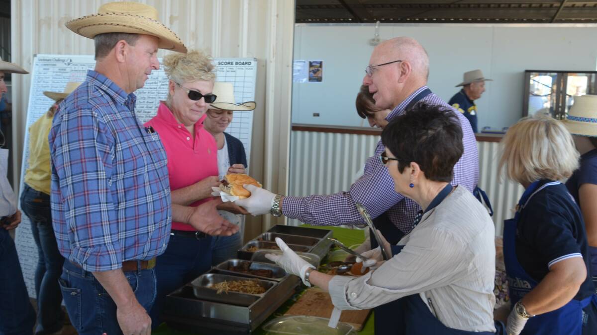 The Governor-General and wife Linda Hurley serve up burgers at the Cloncurry Stockmans Challenge.