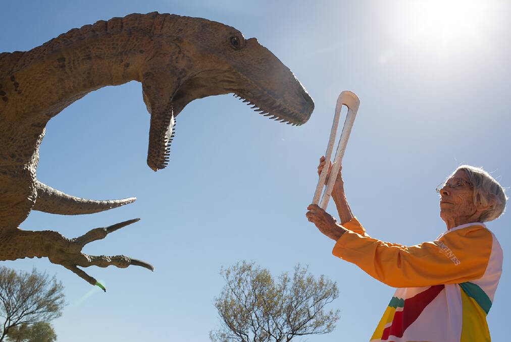 TAKE THAT: Stephanie Greenwood takes the Queen's Baton to the Winton Australian Age of Dinosaurs Museum.
