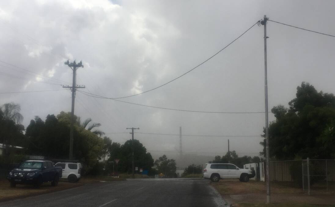 STORM INCOMING: The Mount Isa copper smelter is about to disappear in the clouds in Sunday's wild storm. There were reports of hail, damaging winds and 30mm of rain.  