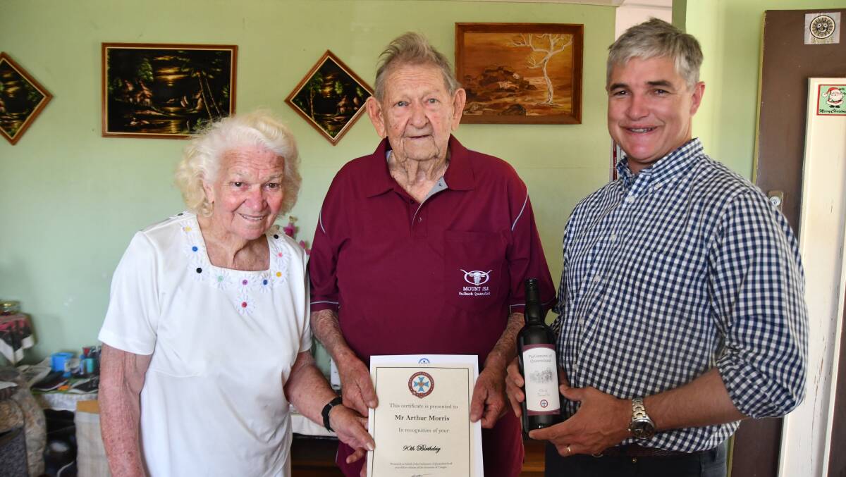 Anne Morris with her husband Arthur Morris who turned 90 on Monday and is presented with a certificate and a bottle of wine by Robbie Katter.