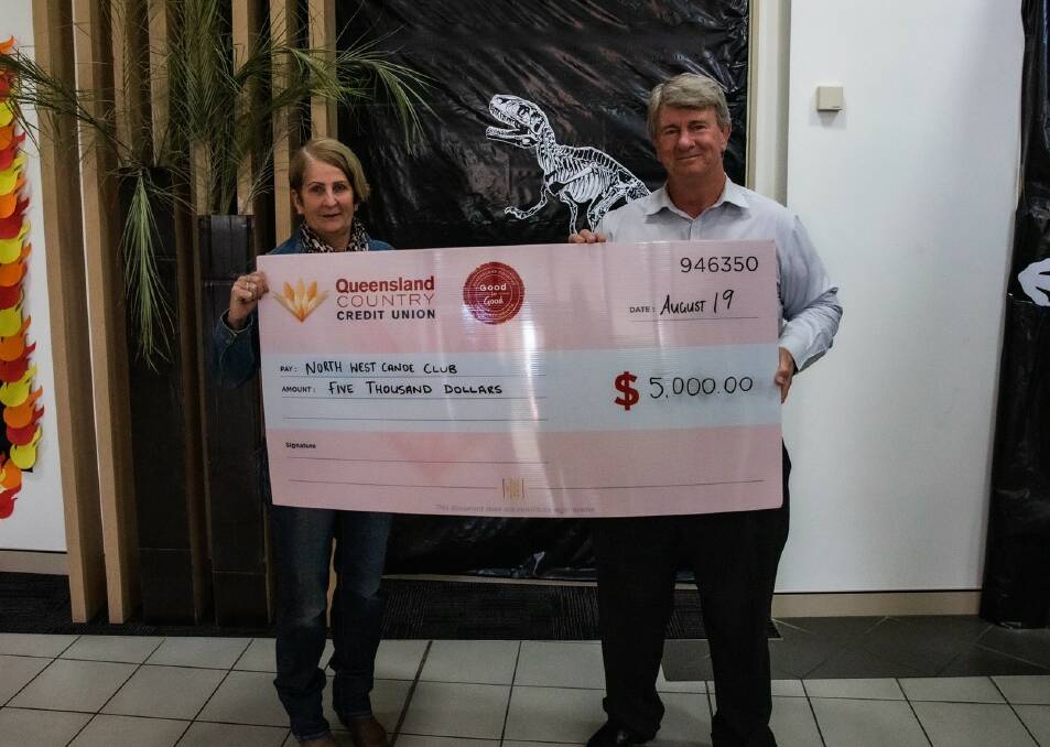 North West Canoe Club's Donna McCormack received $5000 to purchase 12 new paddles from QCCU Mount Isa's Graham Barram.
