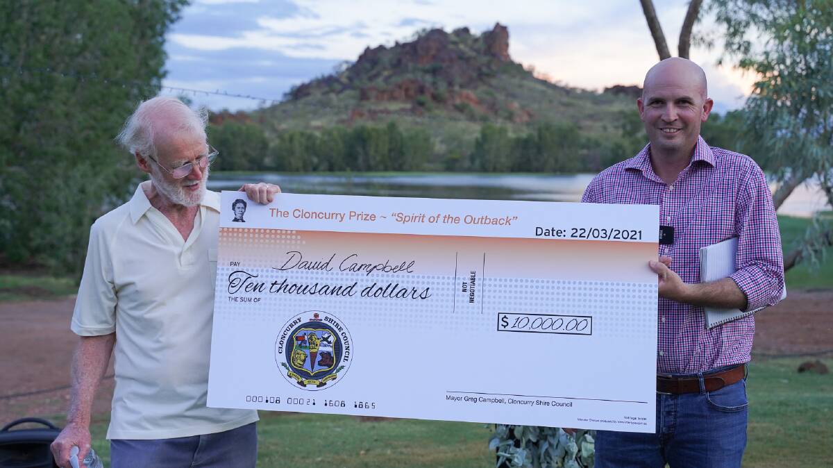 David Campbell gets his cheque for $10,000 from Cloncurry mayor Greg Campbell.