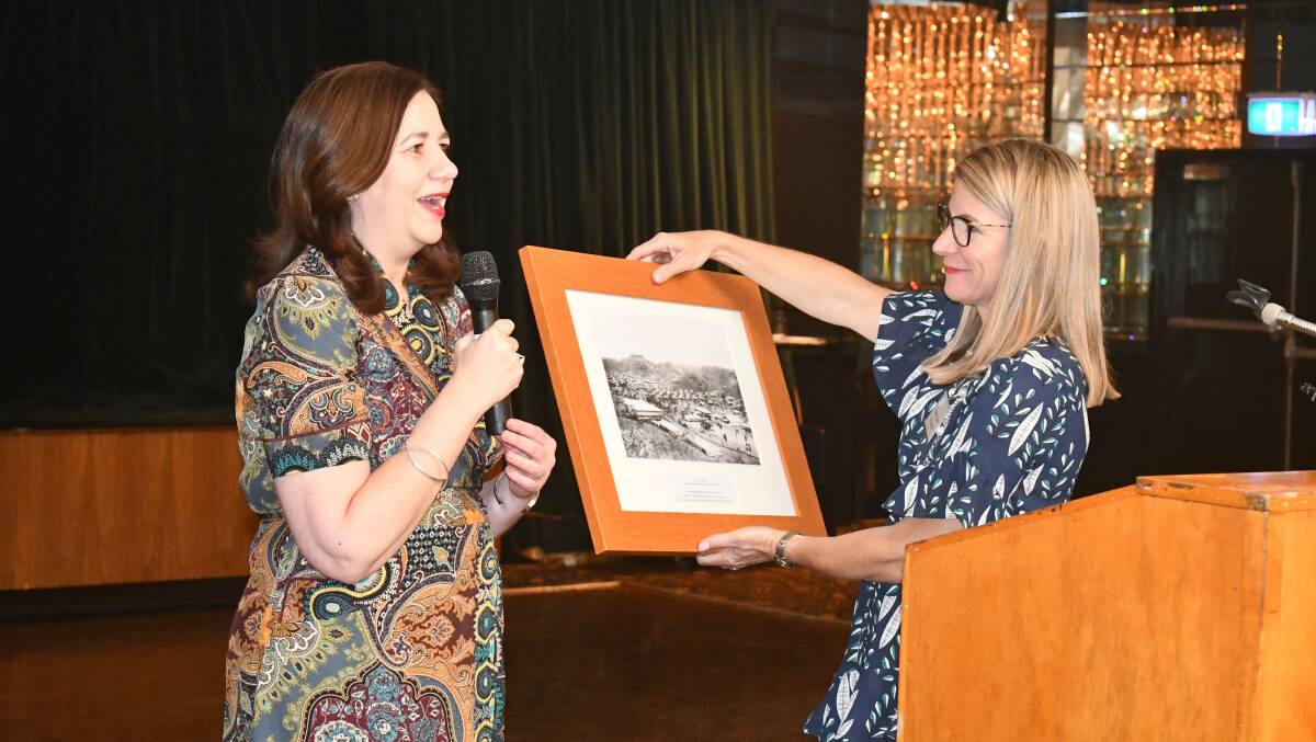 Premier Annastacia Palaszuk presents Mount Isa Mayor Joyce McCulloch a print of Mount Isa in 1932.