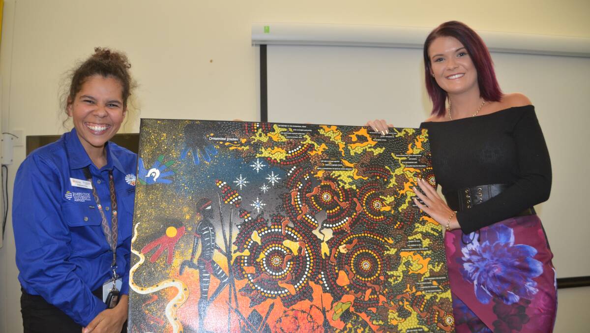 GREAT ART: Steph King and Chern'ee Sutton with the artist's painting Dreamtime Soldier (2014) which she donated to JCU rural health centre.