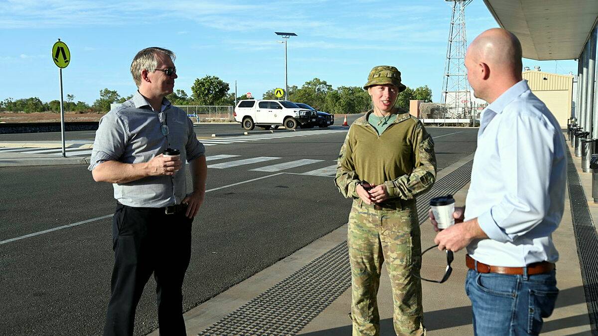 Australian Army pilot Captain Bonnie Hunt from the 5th Aviation Regiment meets with Chief Executive Officer Philip Keirle (left) and Mayor Gregory Campbell (right) to discuss the capability of the MRH90 Taipan helicopter at Cloncurry. Photo: Captain Carolyn Barnett