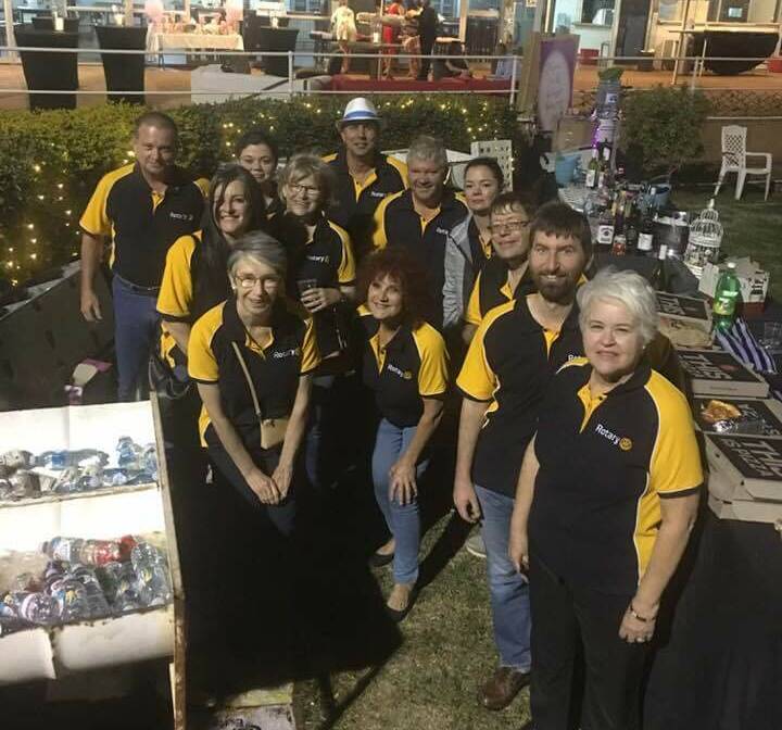 TROOPERS: Rotary Club of Mount Isa South West crew the bar at the Breast Cancer fundraiser on Saturday.