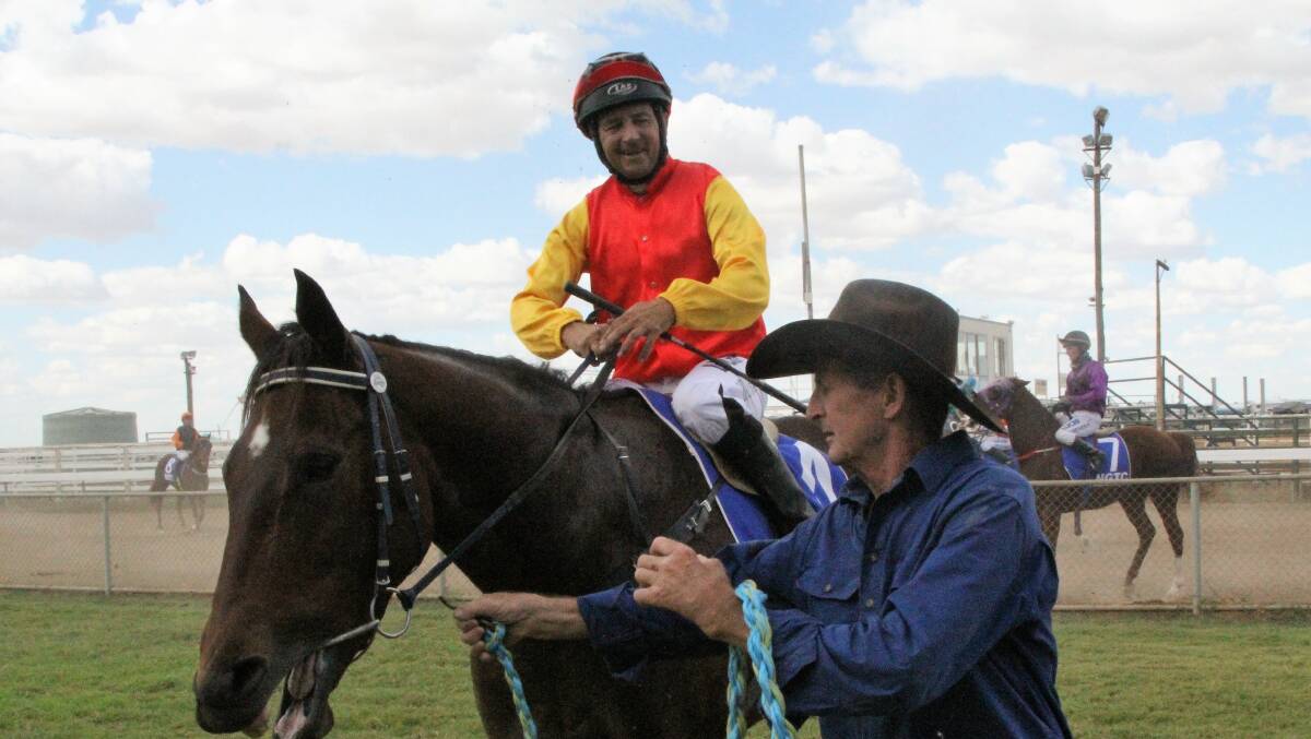 Trainer Ray Hermann congratulates jockey Jason Babarovich as How Big's the Hole, returns to scale after her win in race 3 at Winton.