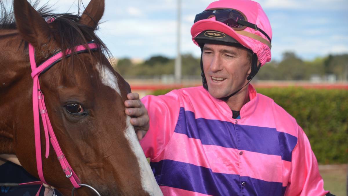 Tim Brummell pats Loud Enough after the race after the pair won the Mount Isa Cup in 2019.