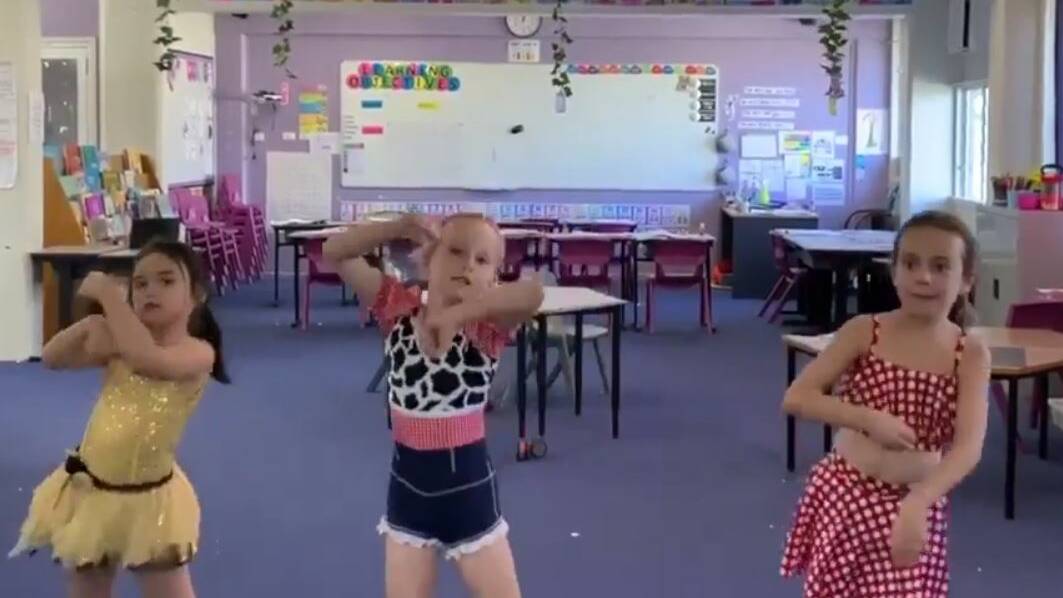 Kiera, Eleanor and Cindy perform a dance on open mic night at Cloncurry State School.