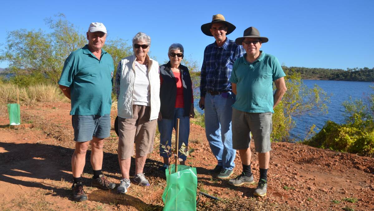LAND CARE: Charles Curry, Rita van Ryt, Judy Boon, Mark Van Ryt and Paul Johnson install tree guards on new trees at the Lake. Photo: Derek Barry
