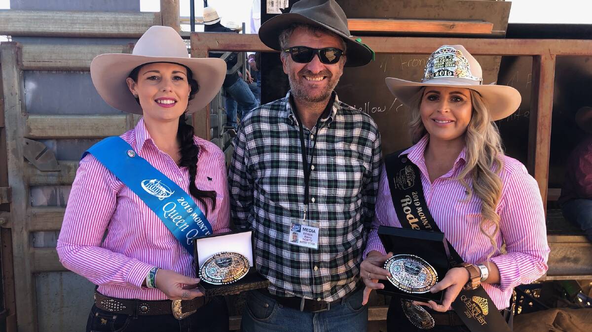 THORN AND ROSES: Rodeo Queen Questers Bron Myers and Aimee Sewell help North West Star editor present the Mount Isa Rodeo team roping buckles, an event sponsored by the paper.