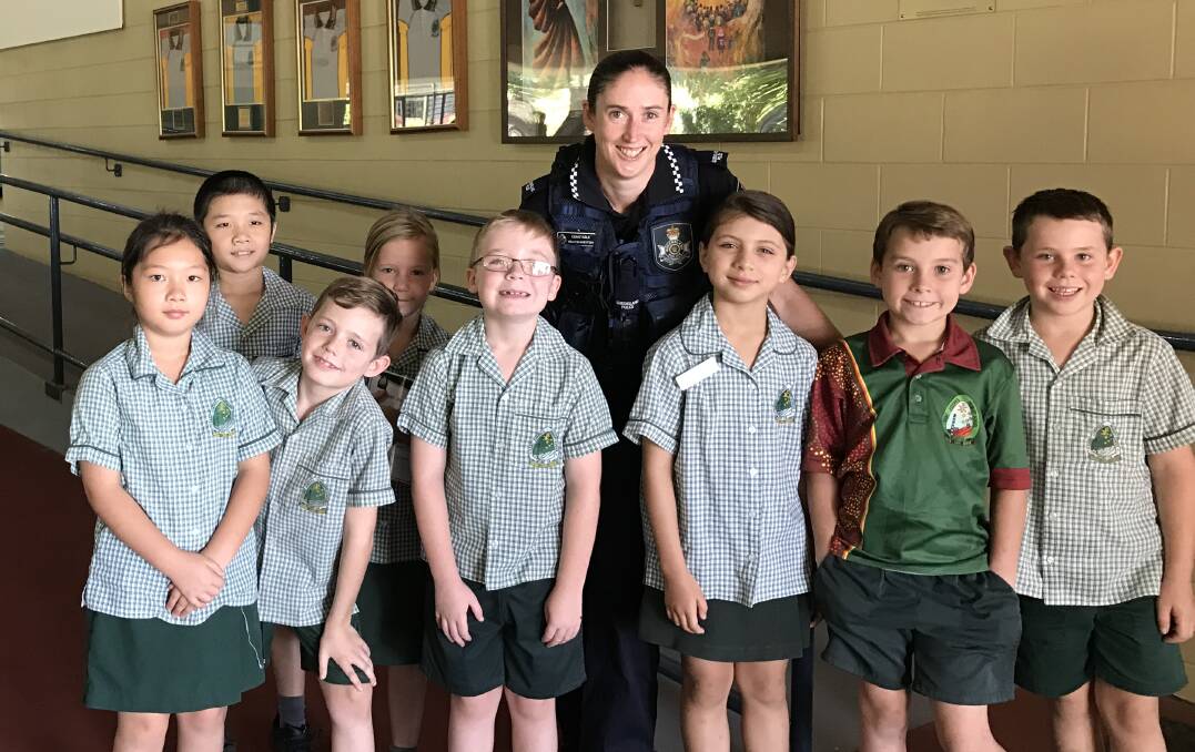St Joseph's Catholic school Mount Isa students with their new adopt-a-cop Constable Kelly Gijsbertsen on March 17.