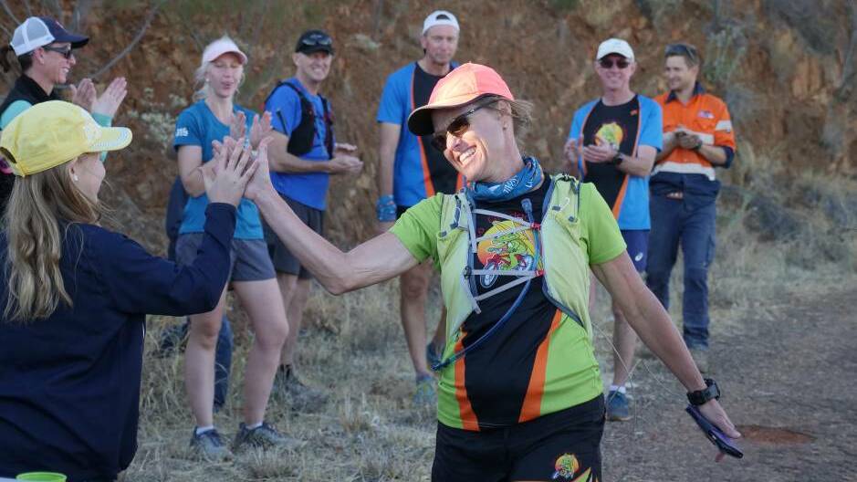 100 LAPS: Alison Whitehead high fives supporters as she finishes her Everest challenge last year. Photo: Kelly Butterworth/ABC North West Queensland.