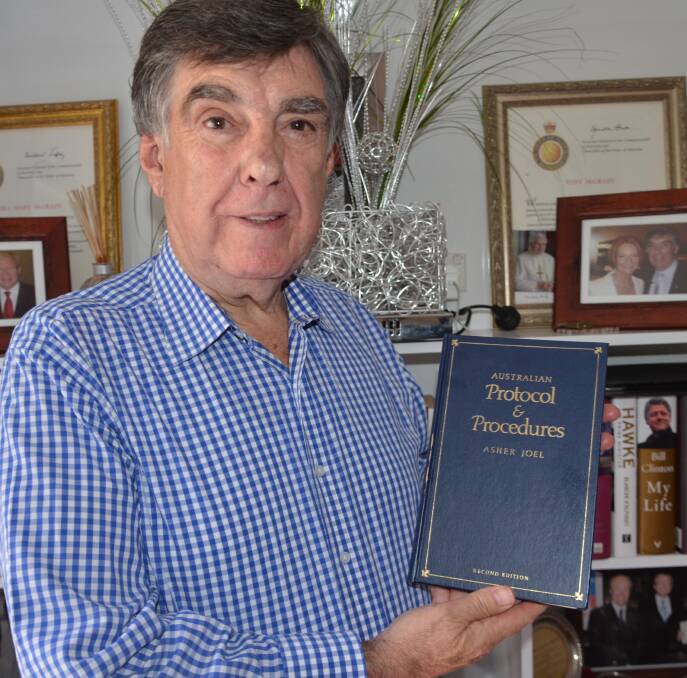 TREASURED MEMORY: Tony McGrady with a proud possession: a signed copy of Sir Asher Joel's book Australian Protocols and Procedures. Photo: Derek Barry