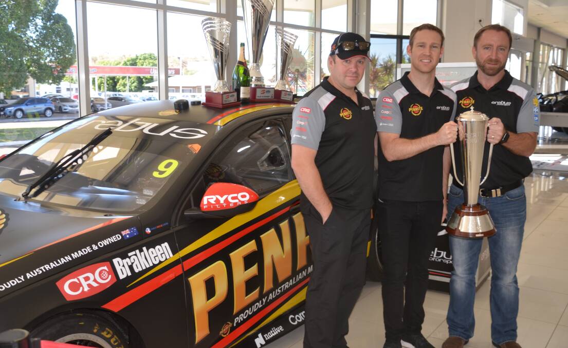 Erebus CEO Barry Ryan, racing driver Dave Reynolds and Malouf Auto principal Paul Malouf hold the Bathurst Peter Brock Trophy Reynolds won in 2017.