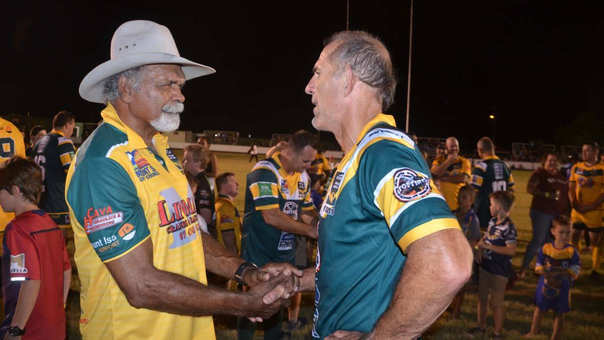 Vern Daisy and Peter Gill shake hands after the Legends of League game in Mount Isa in 2019.