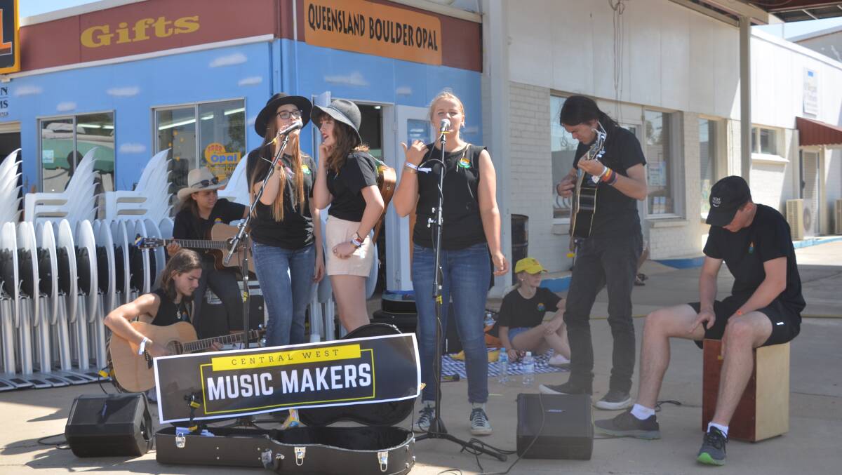 Buskers brave the bugs and flies at Winton's Way Out West festival.