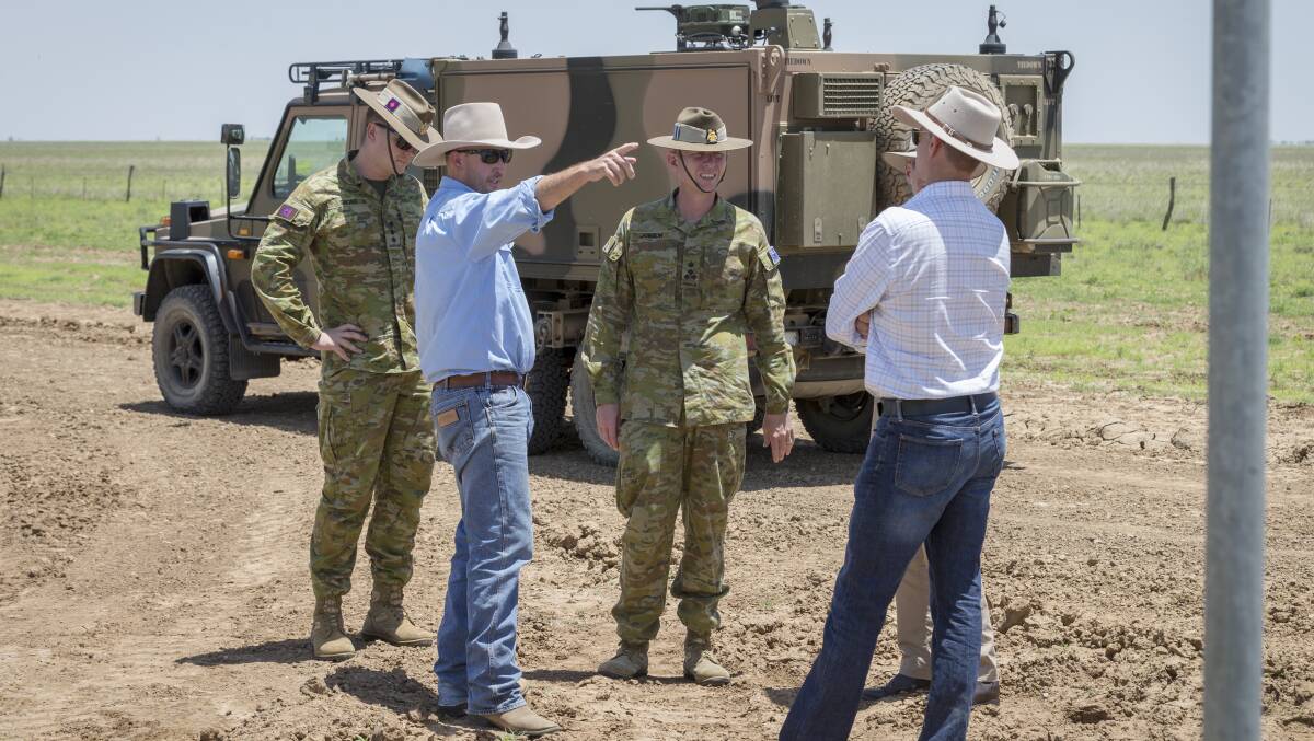 Brigadier Stephen Jobson (centre) discusses carcass management with Cloncurry Mayor Greg Campbell (pointing) and others south of Cloncurry on Saturday.