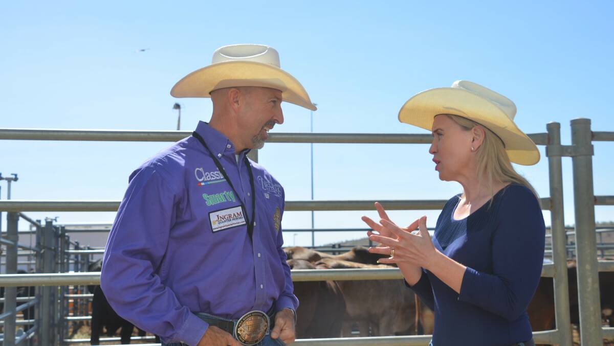 OUTBACK ADVENTURE: Queensland tourism minister Kate Jones chats with American competitor Trey Johnson at the Isa Rodeo. Photo: Derek Barry