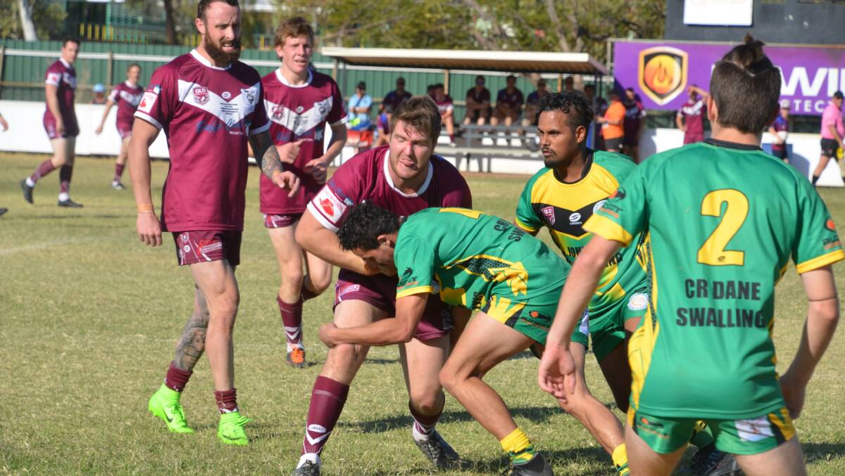 TOUGH TASK: Townies (maroon) and Cloncurry go head to head in the Mount Isa Rugby League grand final. Photo: Derek Barry