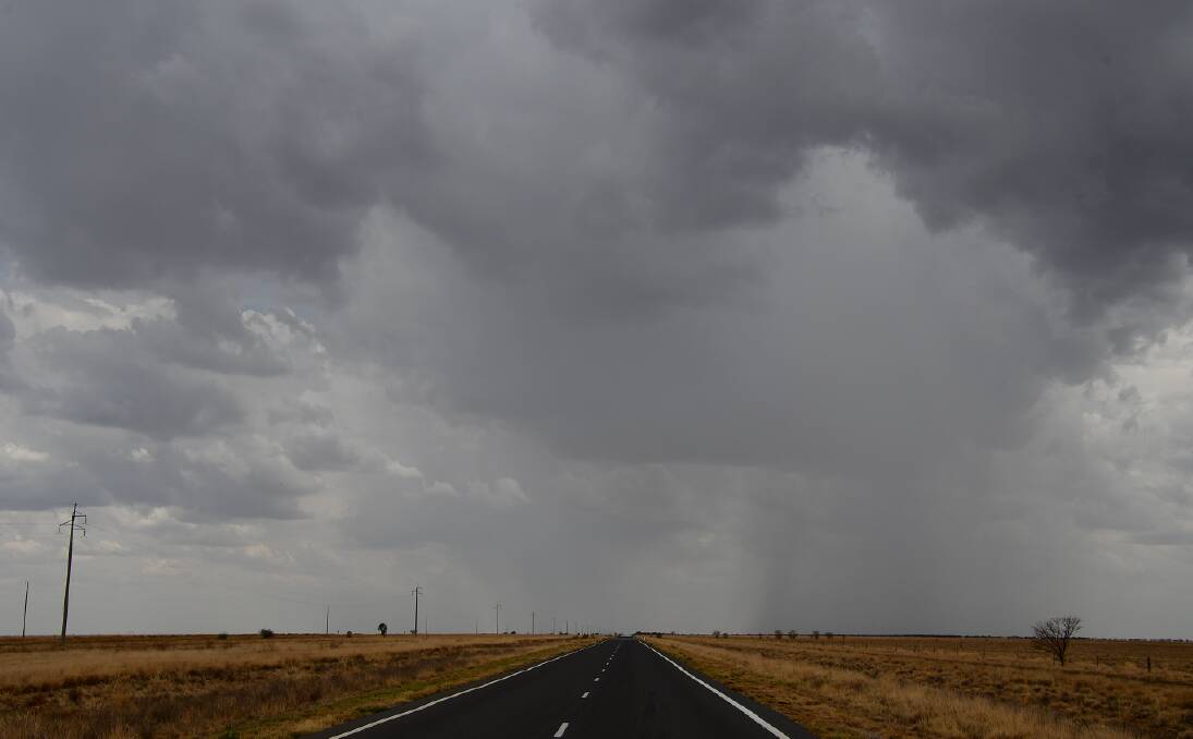 CLOUD NINE: Parts of north west Queensland got some welcome rain on Sunday, including along the Flinders Hwy corridor. Photo: Derek Barry