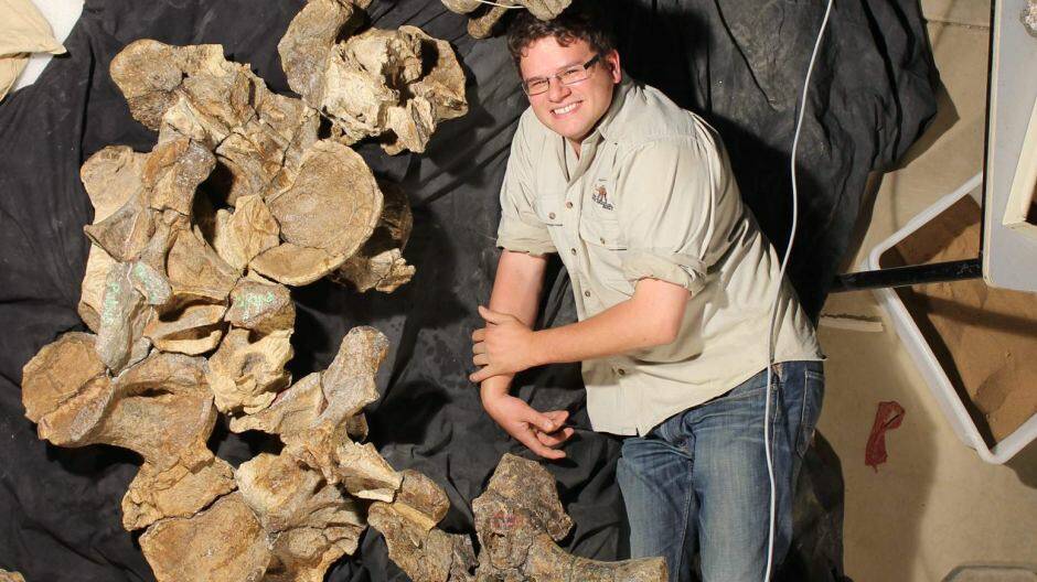 Dr Stephen Poropat with five back vertebrae from the new species of dinosaur, Savannasarus elliottorum. Photo: Judy Elliott