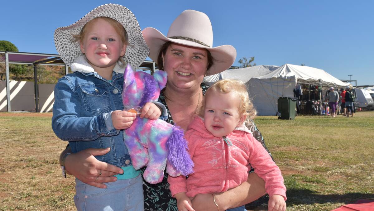 Amanda Cardwell with daughters Sophie, 3, and Paige, 20 months, learned how to do CPR at the show with help from paramedics. Photo: Hannah Baker