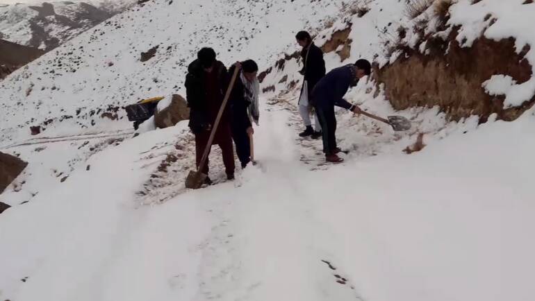 DELIVERY: Volunteers shovel snow from dangerous mountain roads to get vital supplies to desperate families in Afghanistan. Picture: supplied