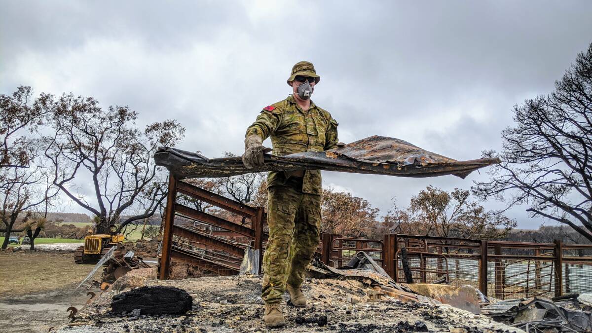 An Army officer helps during Operation Bushfire Assist. Picture Defence Images