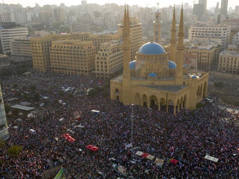Hundreds of thousands of Lebanese protesters have flooded major cities and towns, including Beirut.